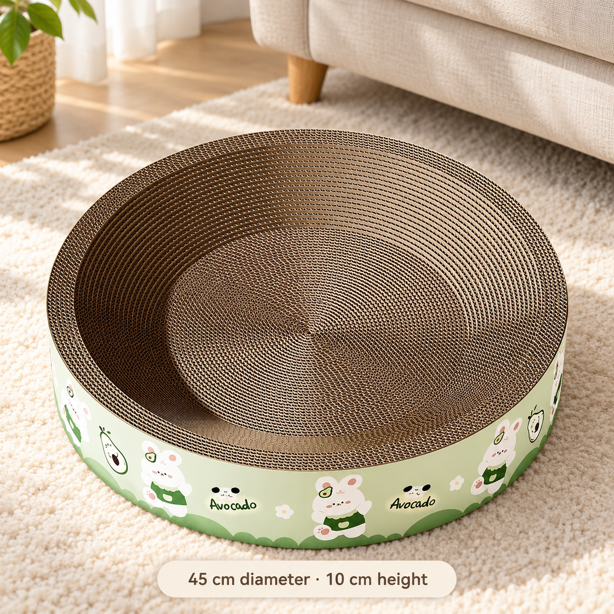 Green avocado print cardboard cat scratcher bed on a cream rug, measuring 45 cm across and 10 cm high