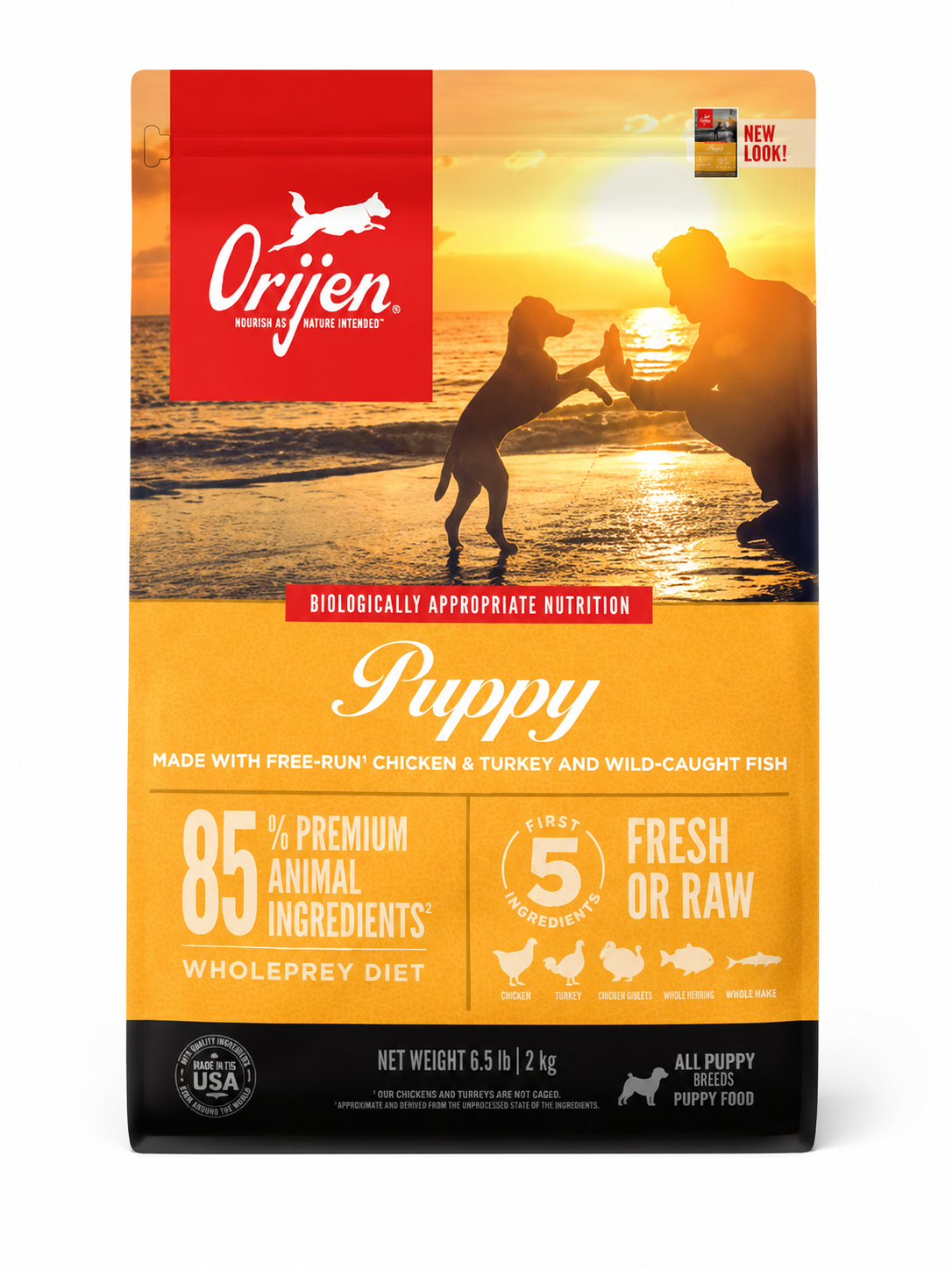 Orijen Puppy dog food bag front packaging on beach sunset with puppy and dog interaction high protein grain free WholePrey nutrition formula