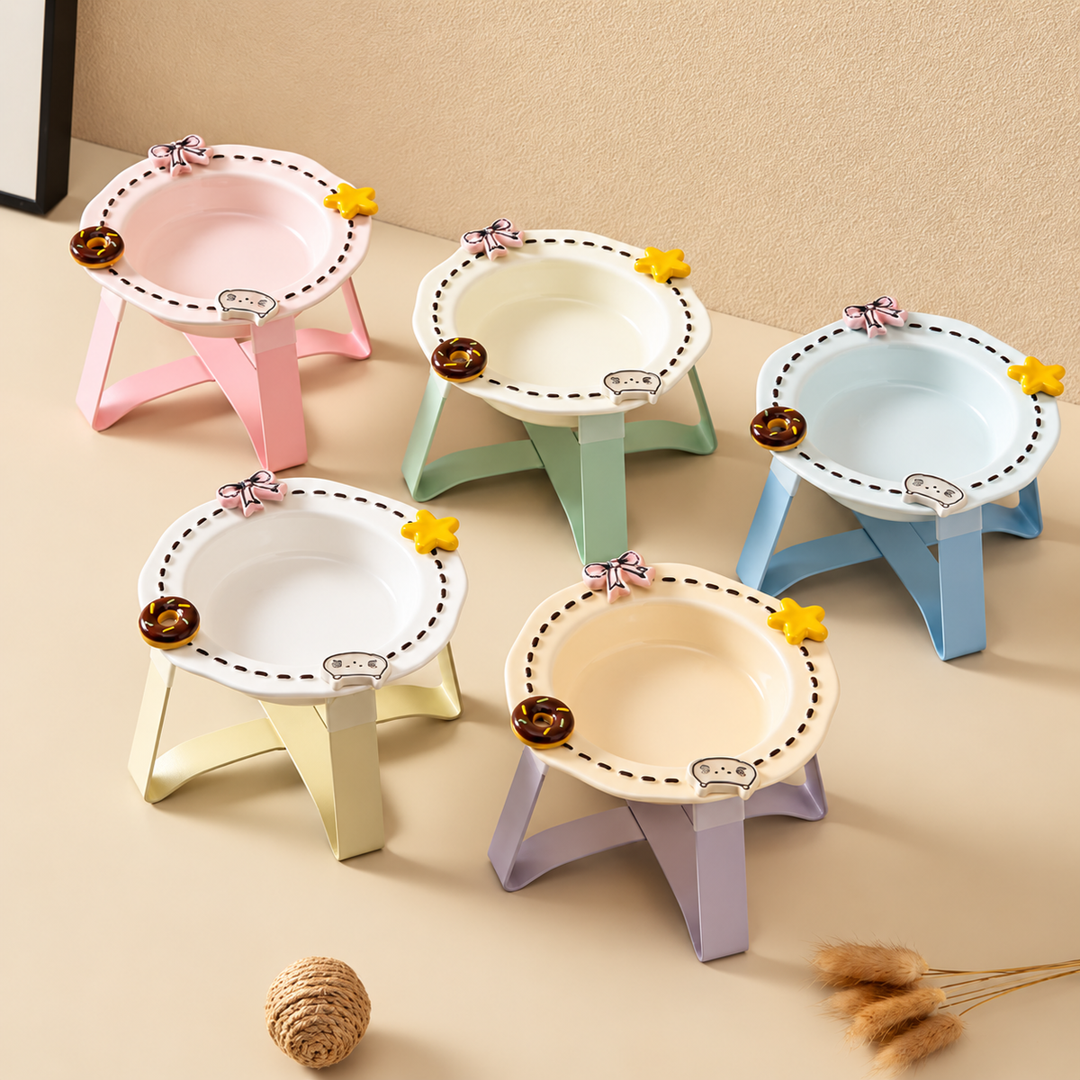 Five decorative raised ceramic cat bowls with colourful folding stands