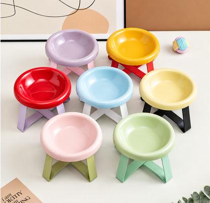 Seven colourful raised ceramic pet bowls with matching folding stands